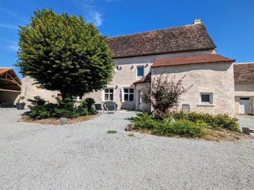 a large stone building with a tree in front of it at Charmant Gîte en Berry avec Étang, Terrasse et Spa à Proximité - FR-1-591-407 in Douadic