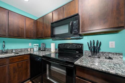 a kitchen with a black stove and a microwave at Central 1BR with Free Parking Near Med Center & NRG Stadium in Houston