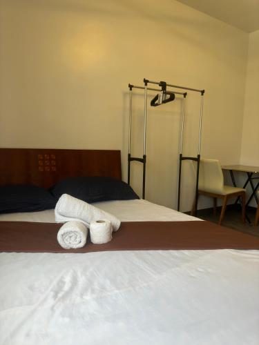 a bedroom with two towels on a bed at Jojies Crib Symfoni Tower 2 Bossa Guadalupe in Cebu City