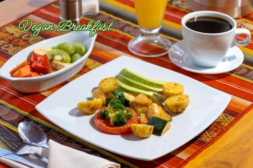 a plate of food with vegetables and a cup of coffee at Friends Hotel & Rooftop - Historic Center & Museums in Quito