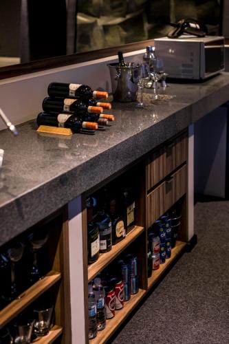 a counter top with bottles of alcohol on it at Kharma Suites in Puebla