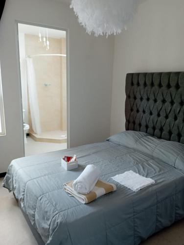 a bedroom with a blue bed with a mirror at Exclusiva Casa con Alberca in Bata