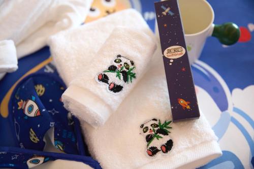 a pair of towels with christmas decorations on them at Mercure Yiwu International Trade City in Yiwu