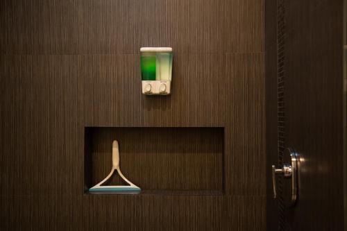 a bathroom with a shower with a toothbrush on the wall at Makari Vallarta in Puerto Vallarta