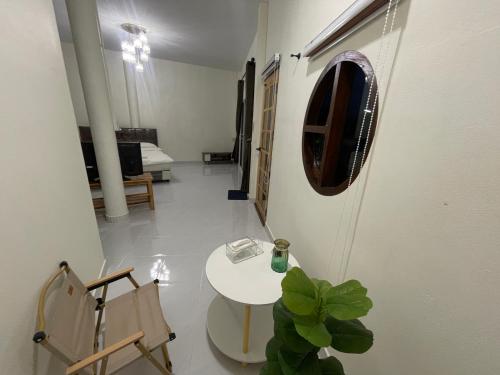 a room with a table and a mirror on the wall at ภูผา เฮ้าส์ รีสอร์ท in Ban Mung