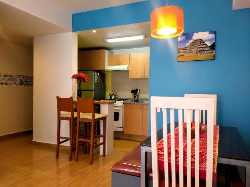 a kitchen and dining room with a table and chairs at El Mirador Centro Histórico in Mexico City