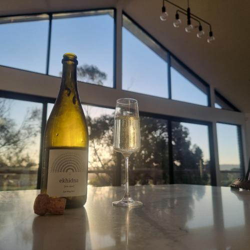 a bottle of wine and a glass on a table at Casena in McCracken