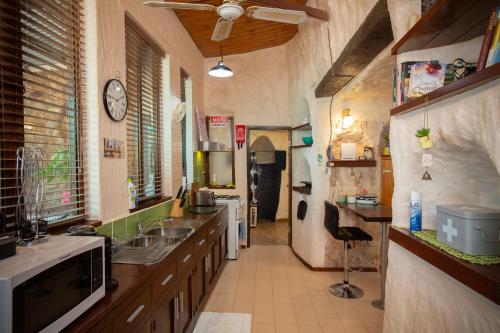 a large kitchen with a sink and a counter at Di's Dugouts in Coober Pedy