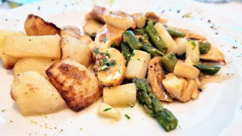 a white plate of food with potatoes and vegetables at Hotel Mediterraneo in Lignano Sabbiadoro