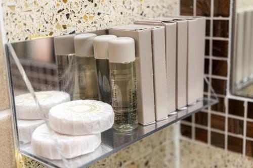 a shelf with soap and other items on it in a bathroom at Hotel Cala Del Porto in Vibo Valentia Marina