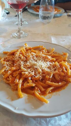 a plate of pasta with cheese on a table at Appartamento 140 mq a pochi minuti da Tropea, 2 bagni in Le Pioppe