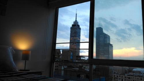 a view of a tall building from a window at El Mirador Centro Histórico in Mexico City