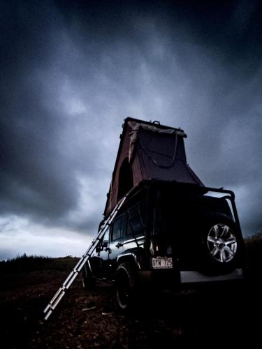 a jeep with a tent on top of it at CampCar Maui Jeeps SUVs Hybrid Camper van Rentals with equipment and Travel Advice in Kahului