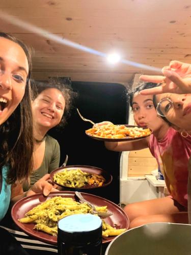 a group of women sitting around a table with plates of food at CampCar Maui Jeeps SUVs Hybrid Camper van Rentals with equipment and Travel Advice in Kahului