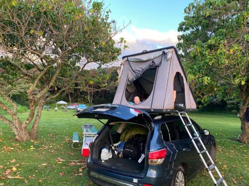a car with a tent on top of it at CampCar Maui Jeeps SUVs Hybrid Camper van Rentals with equipment and Travel Advice in Kahului
