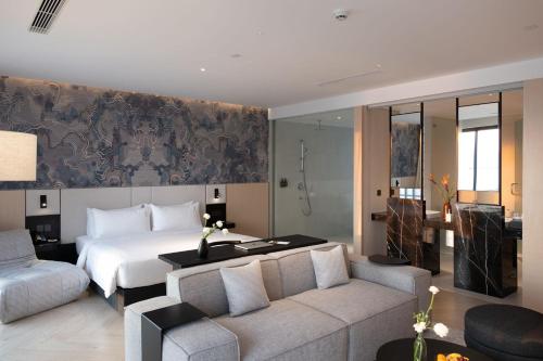 a hotel room with a bed and a couch at December Hotel in Nha Trang