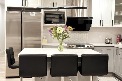 a kitchen with a table with a vase of flowers on it at Dimond Abode Vacation Home #1 Oakland Dimond District in Oakland