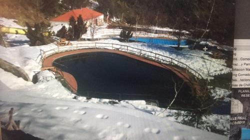 a swimming pool in the snow with snow on the ground at DEPARTAMENTOS TERMAS DE CHILLAN in Nevados de Chillan