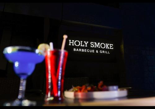 a table with two drinks and a plate of food at Hudson Resorts in Sriperumbudur