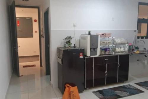 a kitchen with two refrigerators and a door in a room at HomestayTrio Condominium Klang in Klang