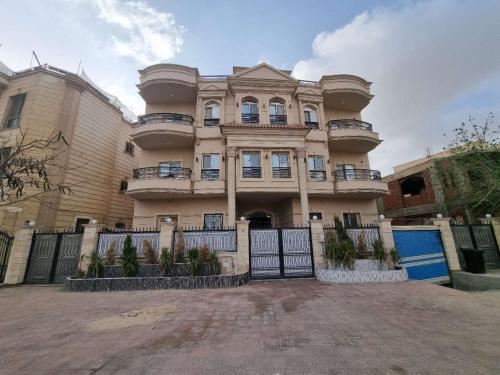 a large house with a fence in front of it at 壹号公馆民宿客房 in Cairo