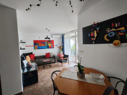 a living room with a table and a couch at Art Gallery House with a small relaxing pool in Crikvenica