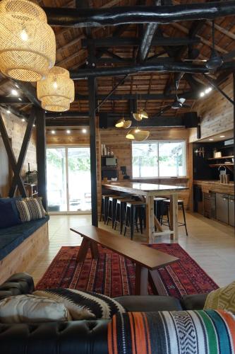 a living room with a couch and a table at ケーブキャビン シービュー BBQ ピザ サウナ ホットタブ - Cave Cabin Chiba Seaview BBQ Pizza Sauna Hot-tub in Kobama
