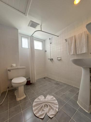 a bathroom with a toilet and a sink at Sunset Mansion in Patong Beach