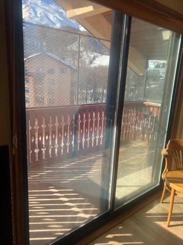 a view of a balcony through a glass window at DEPARTAMENTOS TERMAS DE CHILLAN in Nevados de Chillan