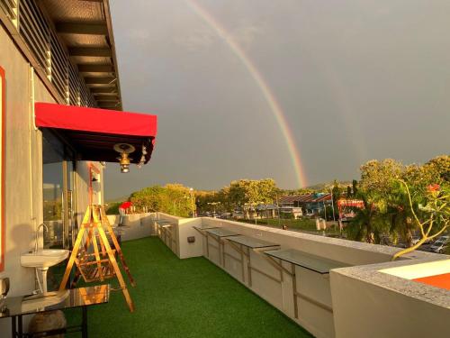 a rainbow over a balcony with a rainbow at RNK BoutiQue HOTEL in Jitra