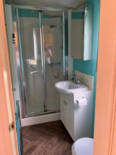 a bathroom with a shower and a sink at Lazeeedays on Mersea Island in Colchester