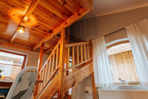 a loft bed in a room with a wooden ceiling at Rezi Pava in Pava