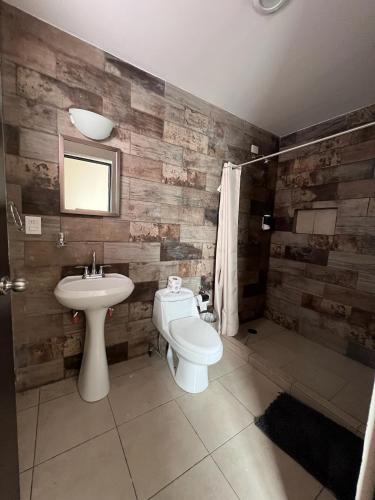 a bathroom with a sink and a toilet and a mirror at Casa Isla Marina Vista al Mar 20 Personas in Mazatlán