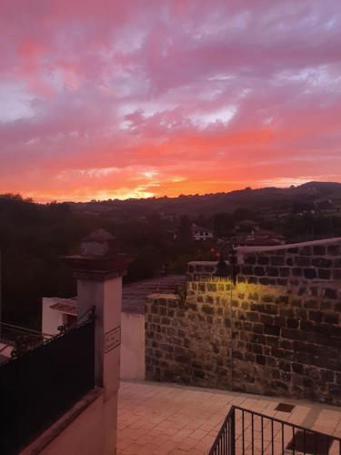 a sunset from the top of a building at Dimora Storica Apartments in Ruviano