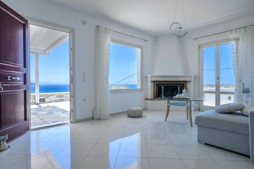 a living room with a view of the ocean at ‘Sophie’s Villa’ in Naxos Chora