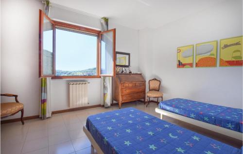 a bedroom with two beds and a desk and a window at Casa Bellavista in Le Grazie