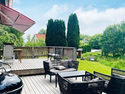 a patio with chairs and a couch on a deck at 4 person holiday home in STILLINGSÖN in Stillingsön