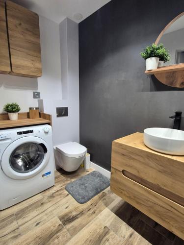 a bathroom with a washing machine and a toilet at Chill in Lubrza in Lubrza