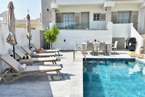 a swimming pool with chaise lounge chairs and a swimming pool at Melia Casa in Rhodes Town