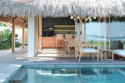 a resort with a swimming pool and a restaurant at Amber Lombok Beach Resort in Selong Belanak
