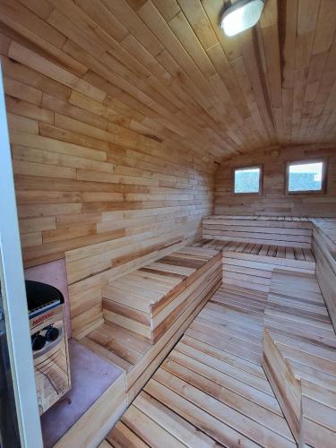 an empty wooden sauna with a stove in it at Hani's Partyhaus in Verl