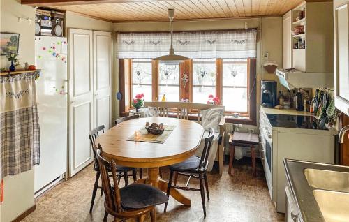 a kitchen with a table and chairs in a kitchen at Stunning Home In Ydre With Kitchen in Basarp