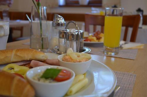 a table with a plate of food on a table at V62 studio apartments- Downtown Sopron in Sopron