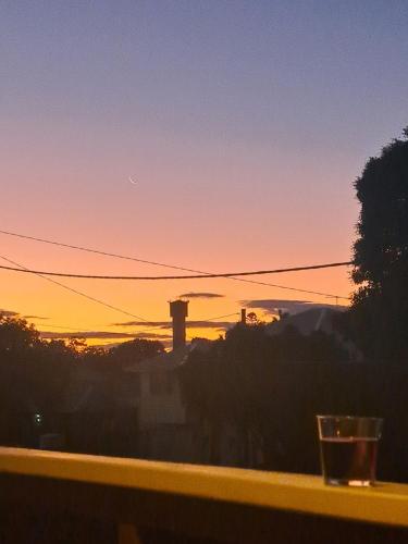a view of a sunset from a window at Brisbane 1960s Pool House - hosted bed and breakfast in Brisbane