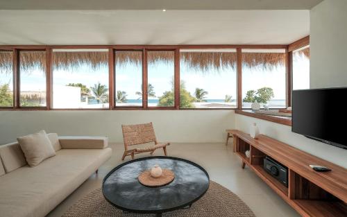 a living room with a couch and a table at Amber Lombok Beach Resort in Selong Belanak