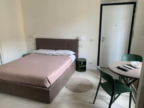 a bedroom with a bed and a table and chairs at Harmony Navigli Apartment in Milan