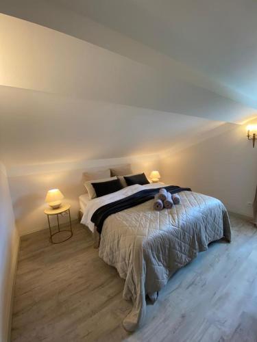 a bedroom with a large bed with two tables at Clos d'Aurelia, Gîte de charme in Mérignas