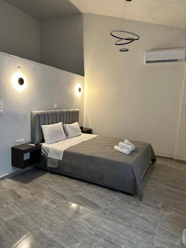 a bedroom with a bed with two towels on it at NATALIE'S APARTMENTS in Mákri