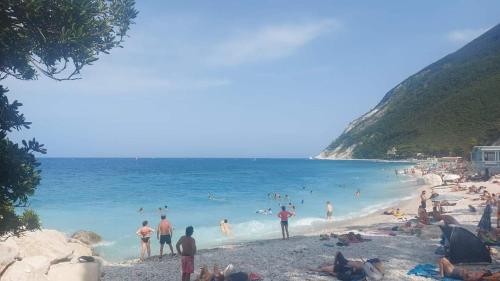 a group of people on a beach in the water at Civico11 in Ancona