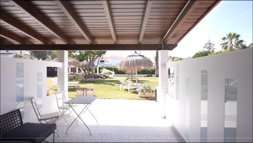 a patio with chairs and a table and a porch at Hotel Malaga Picasso in Málaga